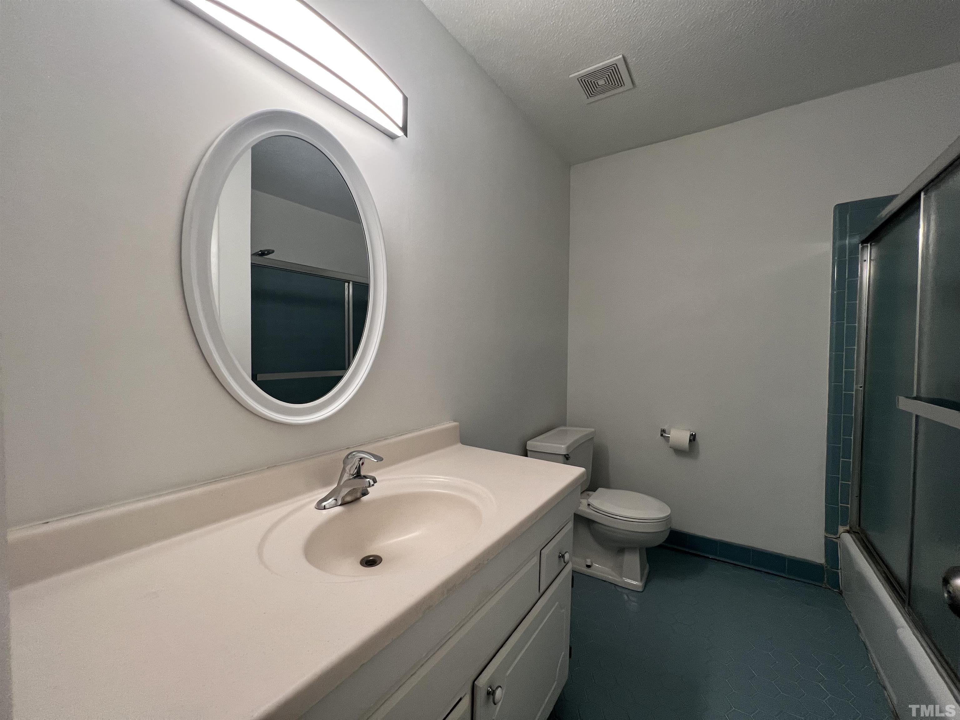 104 Marion Drive Erwin, NC 28339 - Photo 22 of 28 a bathroom with a sink a toilet and a mirror