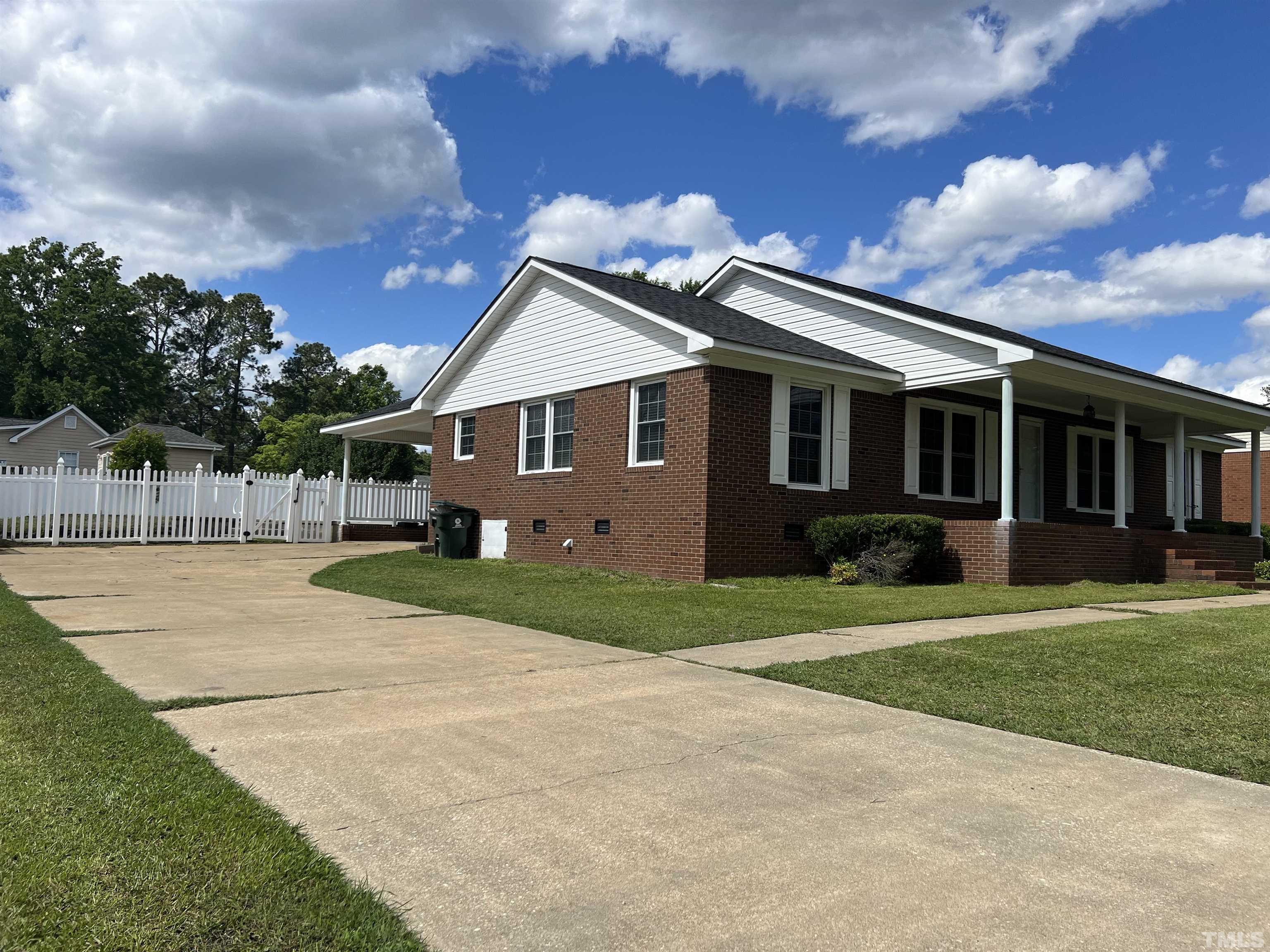 104 Marion Drive Erwin, NC 28339 - Photo 3 of 28 a front view of a house with a garden