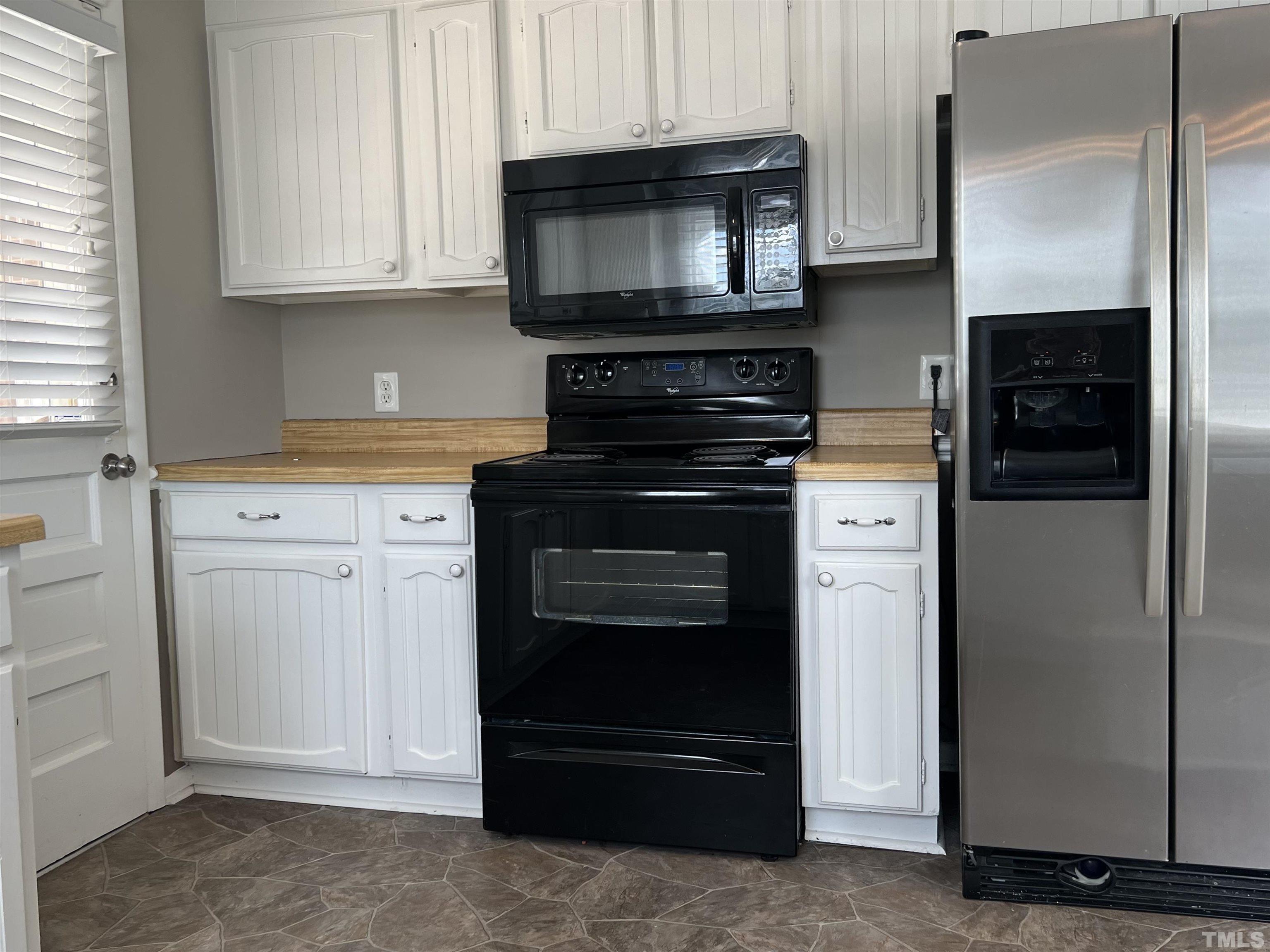 104 Marion Drive Erwin, NC 28339 - Photo 8 of 28 a kitchen with granite countertop white cabinets and stainless steel appliances