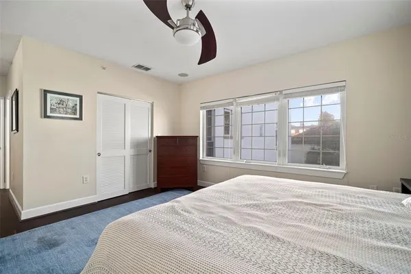 a large kitchen with a large window and stainless steel appliances