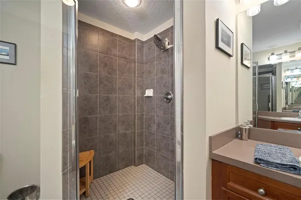 a metallic refrigerator freezer sitting in a kitchen