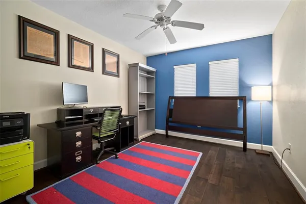 a room with wooden floor and flat screen tv