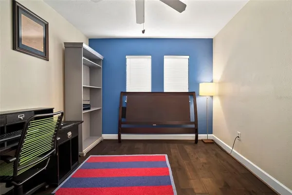 a spacious bedroom with a bed and a dresser