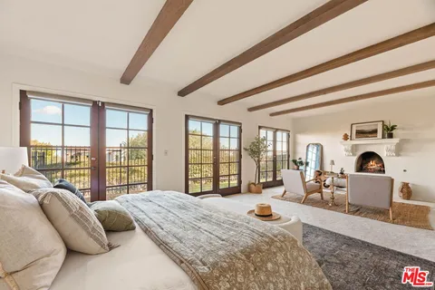 a bedroom with a large bed and a dresser