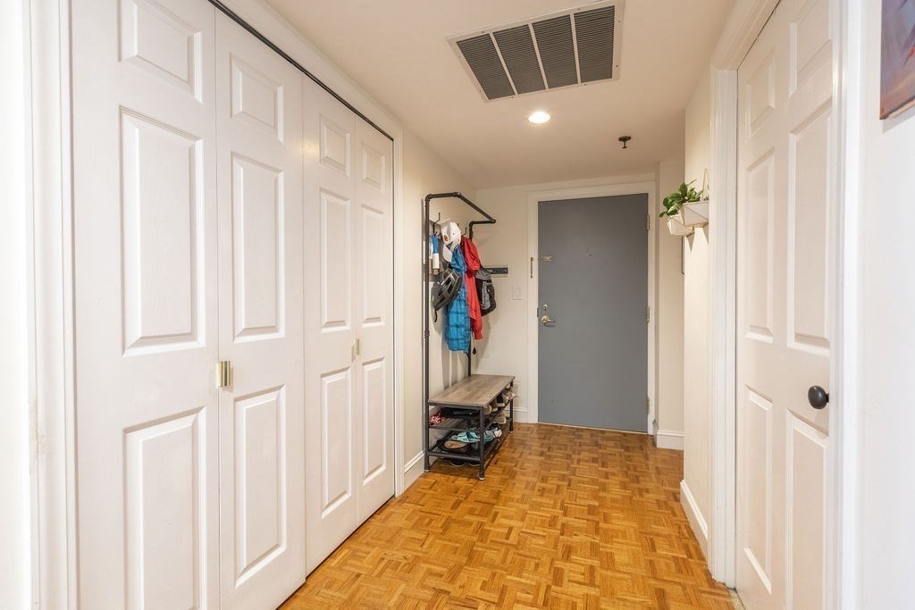 416 Commonwealth Avenue, Unit 212 Boston, MA 02215 - Photo 11 of 19 a view of a hallway with wooden floor and closet