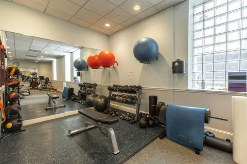 a room with gym equipment and a large window