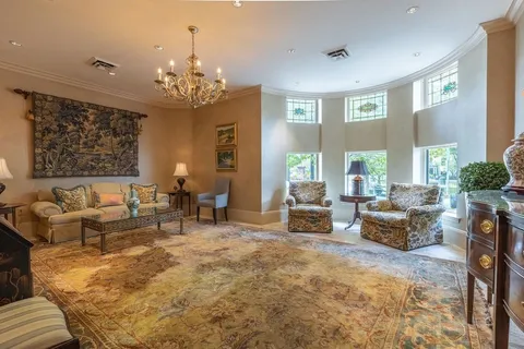 a living room with furniture and a chandelier