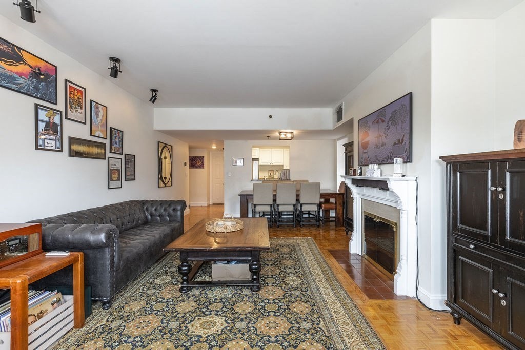 416 Commonwealth Avenue, Unit 212 Boston, MA 02215 - Photo 3 of 19 a living room with furniture flat screen tv and a fireplace