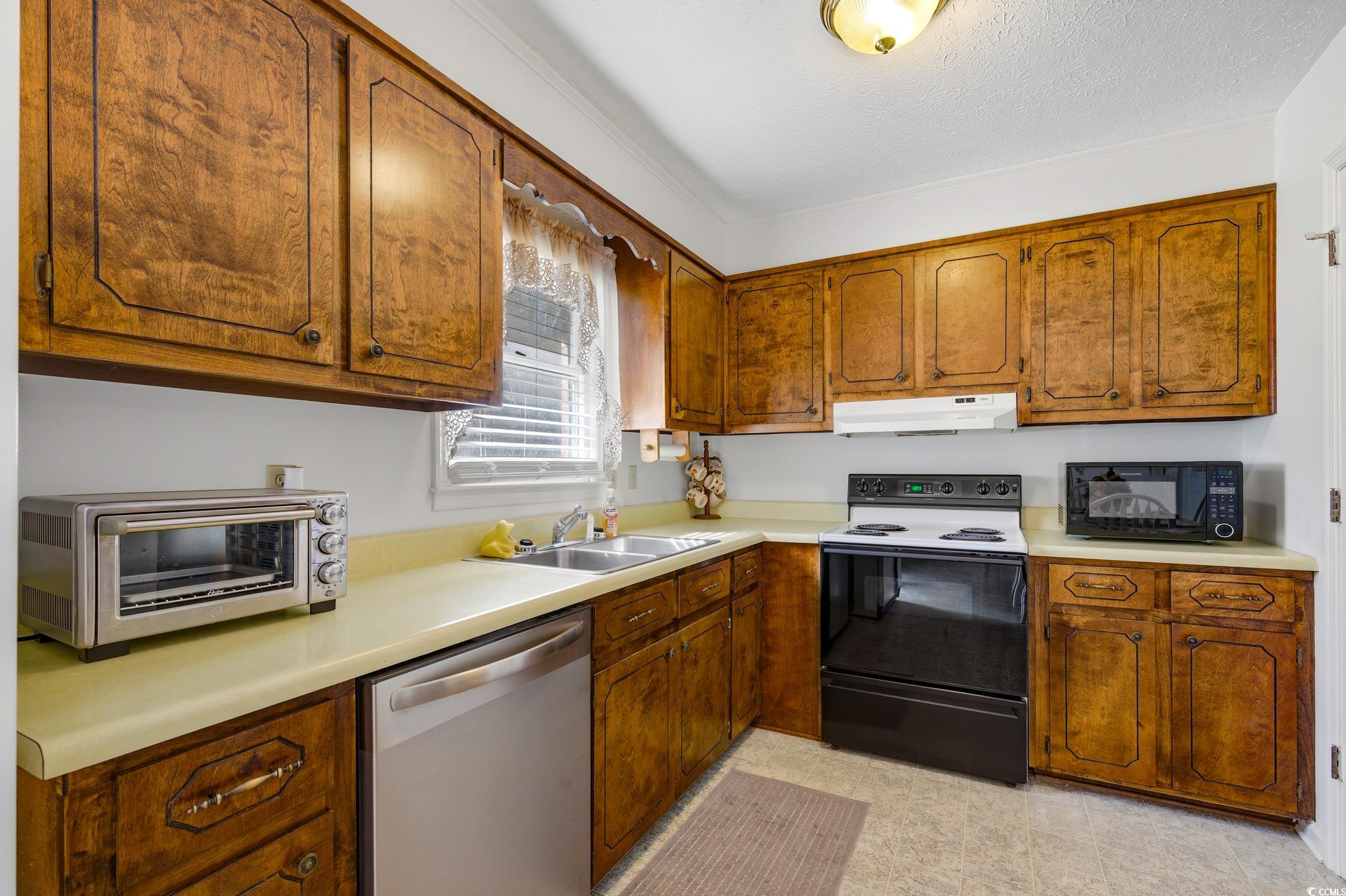 1605 Sessions Street Conway, SC 29526 - Photo 11 of 20 Kitchen with electric range, stainless steel dishwasher, brown cabinets, light countertops, and black microwave