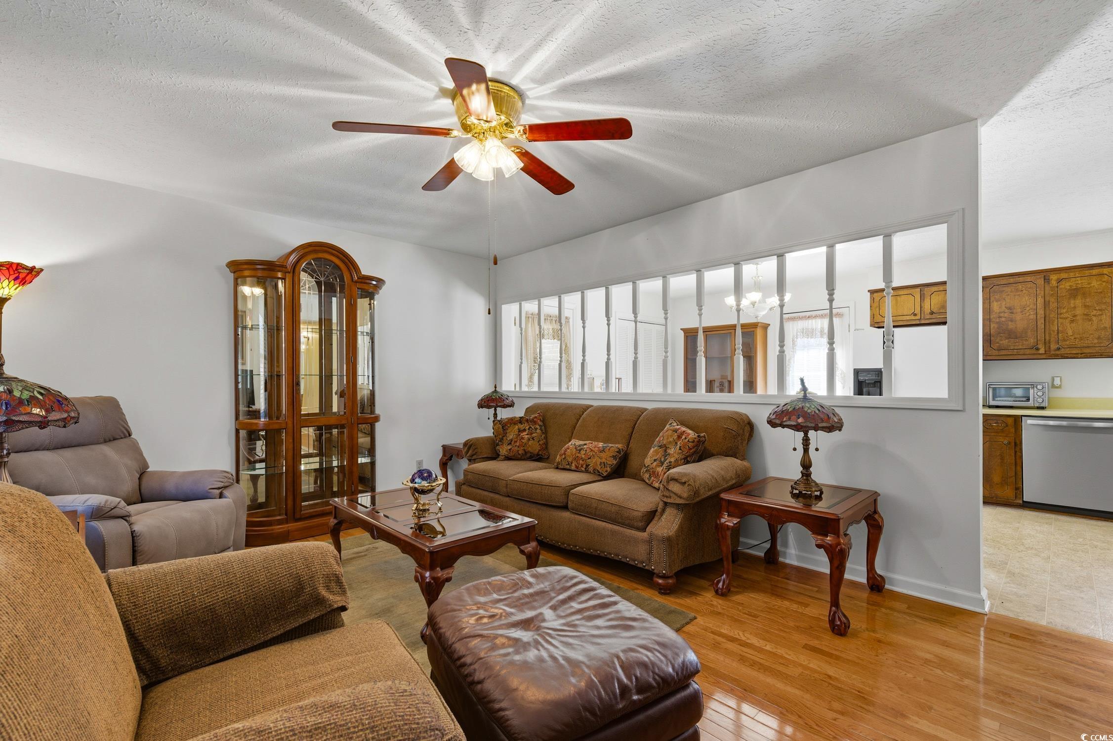 1605 Sessions Street Conway, SC 29526 - Photo 13 of 20 Living area featuring light wood-style flooring, a textured ceiling, and a ceiling fan