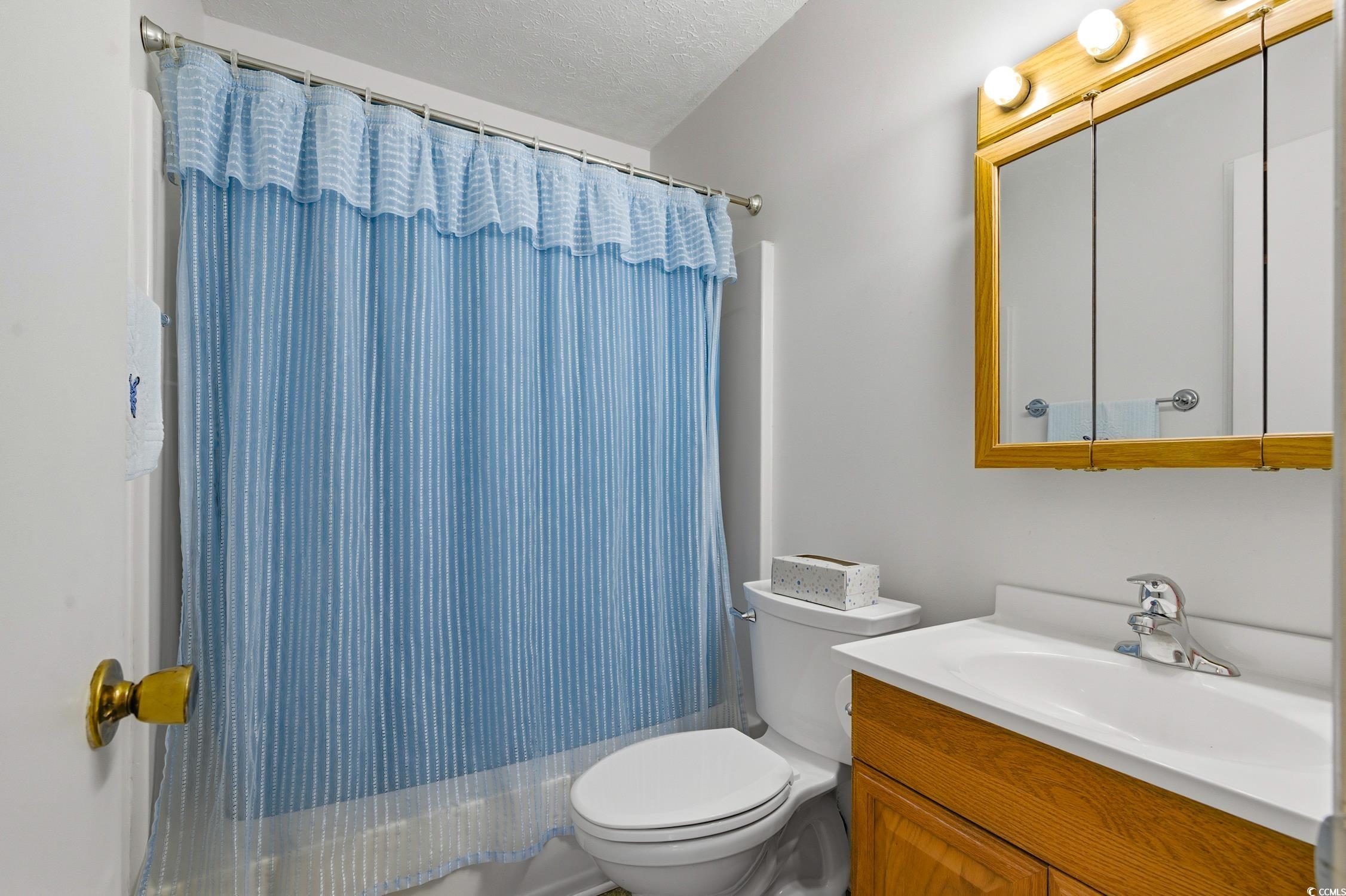 1605 Sessions Street Conway, SC 29526 - Photo 14 of 20 Full bathroom featuring a textured ceiling, vanity, and a shower with shower curtain