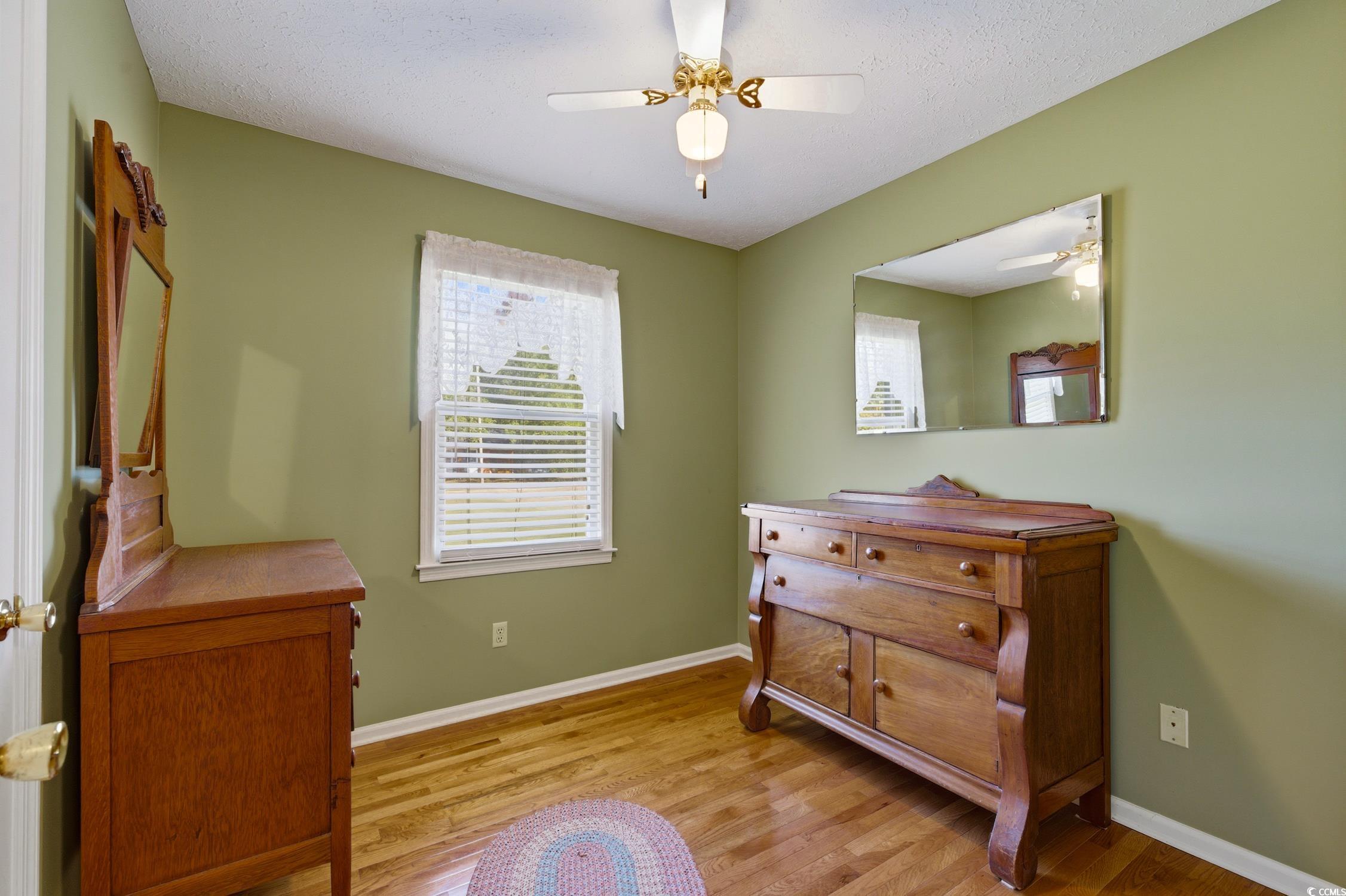 1605 Sessions Street Conway, SC 29526 - Photo 18 of 20 Living area featuring light wood-style flooring, a ceiling fan, and a textured ceiling