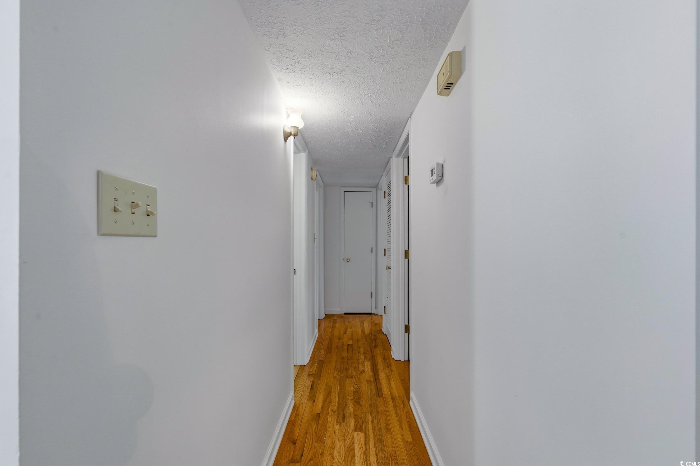 1605 Sessions Street Conway, SC 29526 - Photo 20 of 20 Hall with a textured ceiling and light wood finished floors