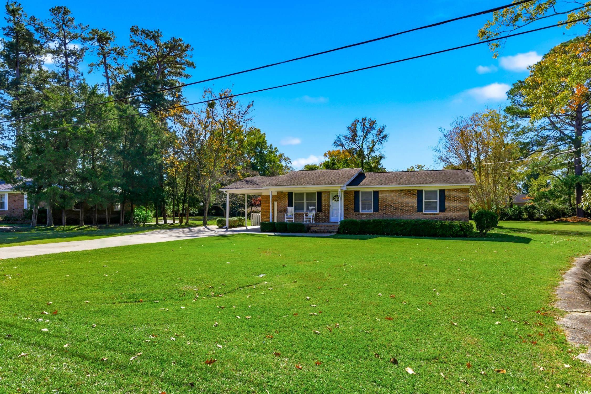 1605 Sessions Street Conway, SC 29526 - Photo 2 of 20 Ranch-style home with covered porch, driveway, a front yard, brick siding, and an attached carport