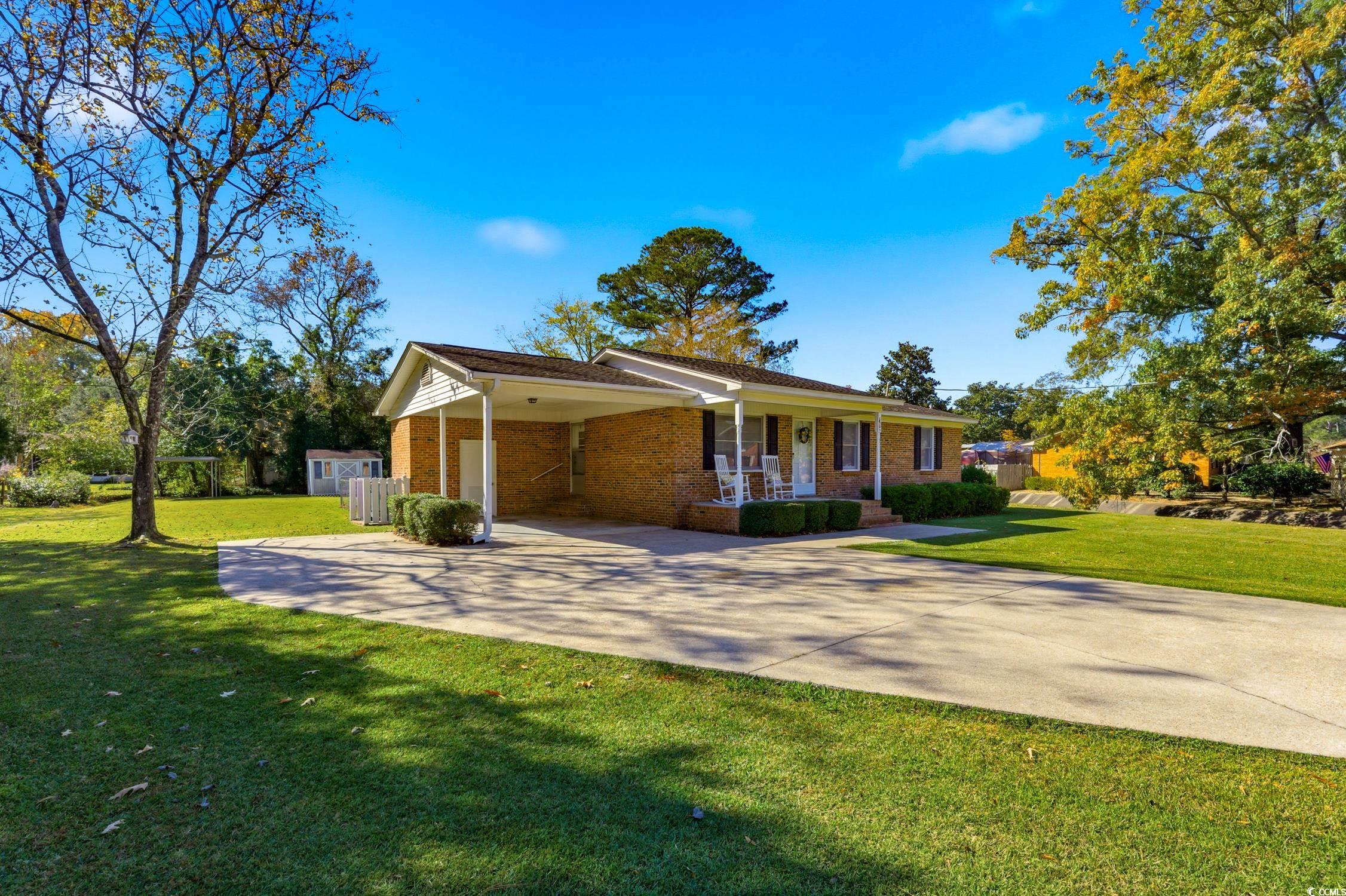 1605 Sessions Street Conway, SC 29526 - Photo 3 of 20 View of front of house with a front lawn, driveway, a porch, a carport, and brick siding