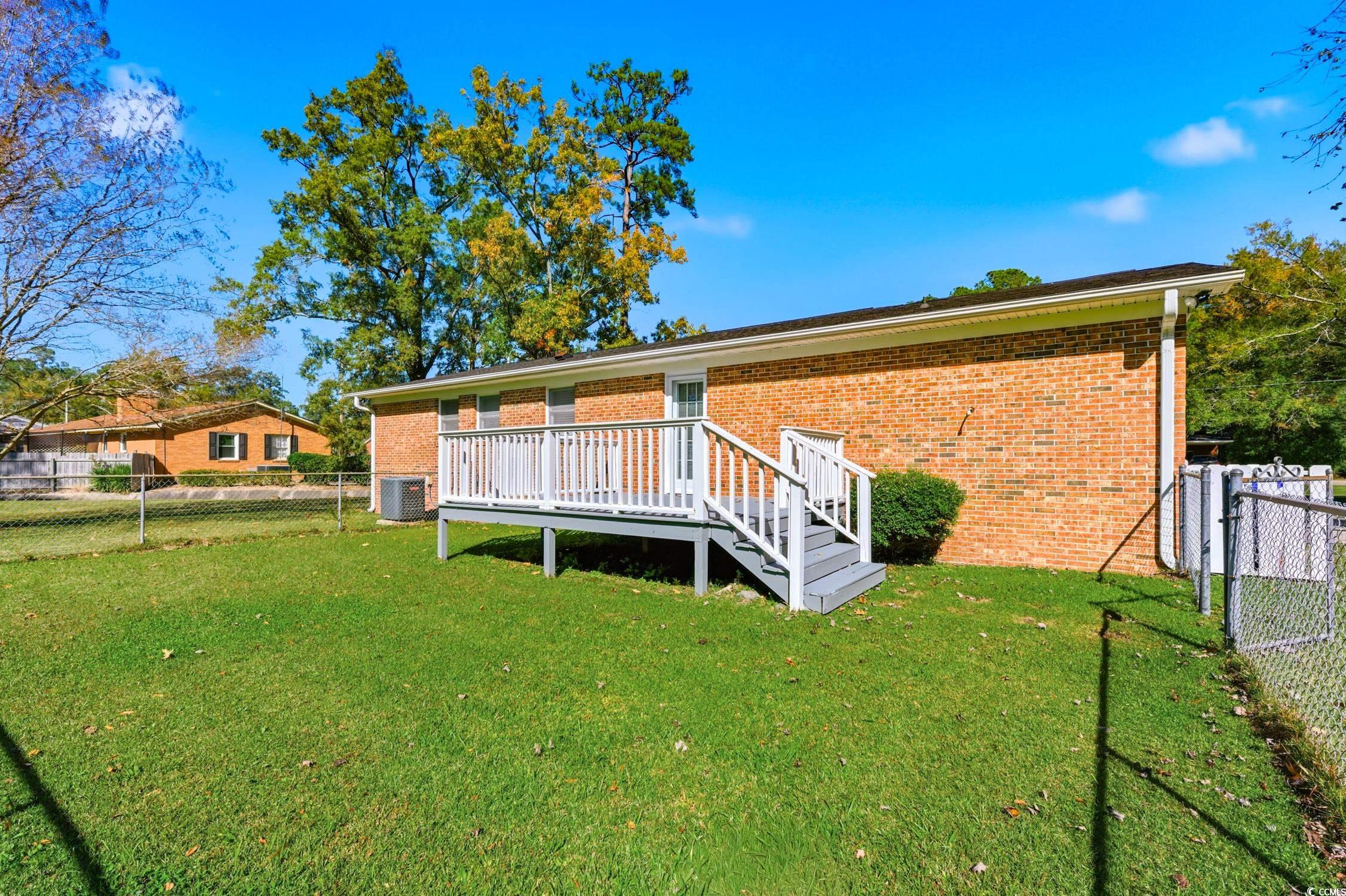 1605 Sessions Street Conway, SC 29526 - Photo 5 of 20 Rear view of property featuring a fenced backyard, brick siding, a deck, a gate, and stairs