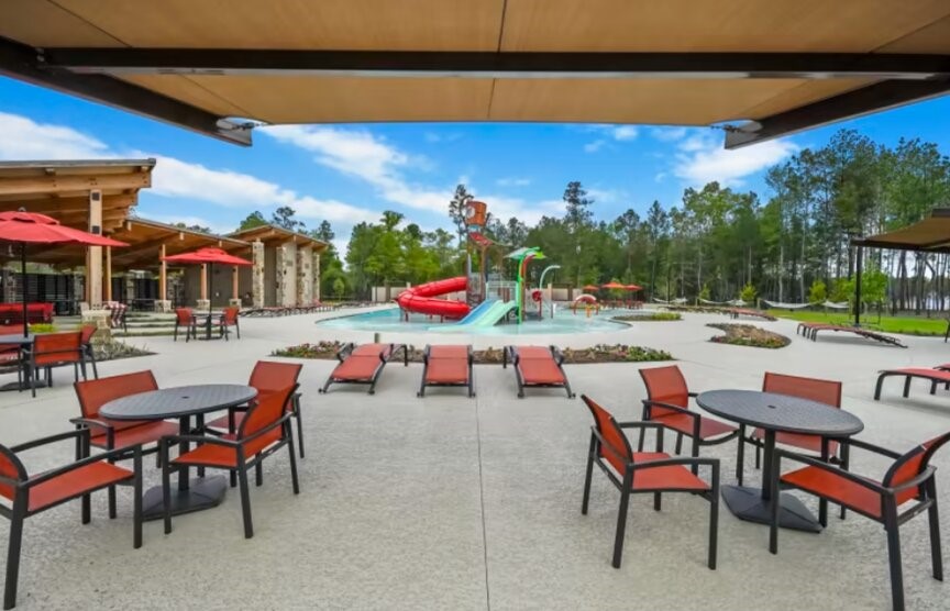 15921 Hayes Mkt Loop Conroe, TX 77302 - Photo 10 of 13 a view of a swimming pool with outdoor seating