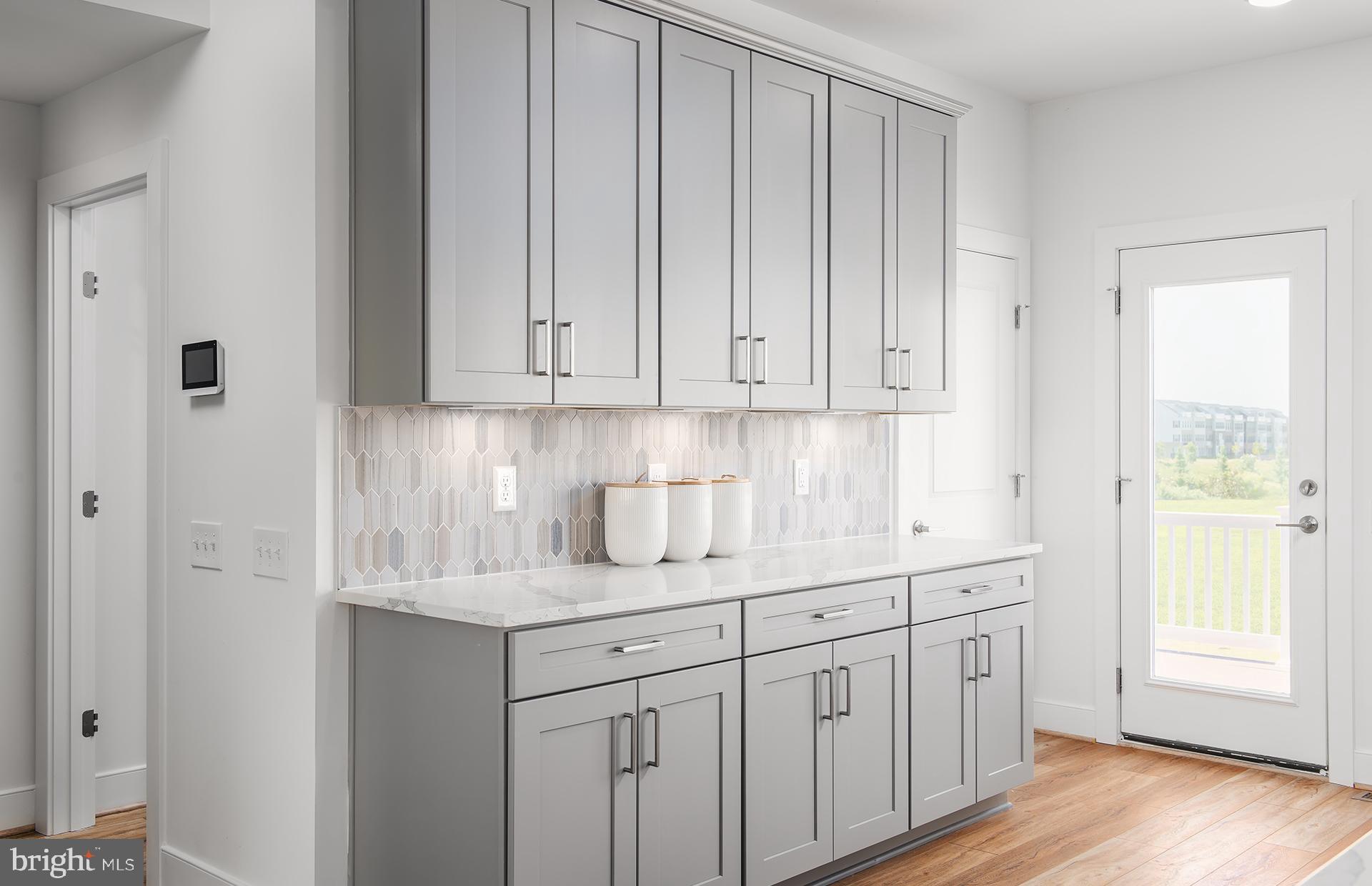 307 Benthic Way Laurel, MD 20724 - Photo 6 of 33 a kitchen with stainless steel appliances granite countertop a sink and dishwasher with wooden floor