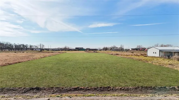 a view of a field with an ocean