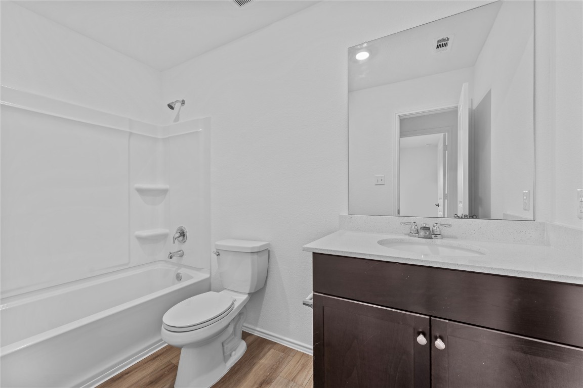 600 The Ugly Way Jarrell, TX 76537 - Photo 16 of 33 a bathroom with a sink a toilet and shower