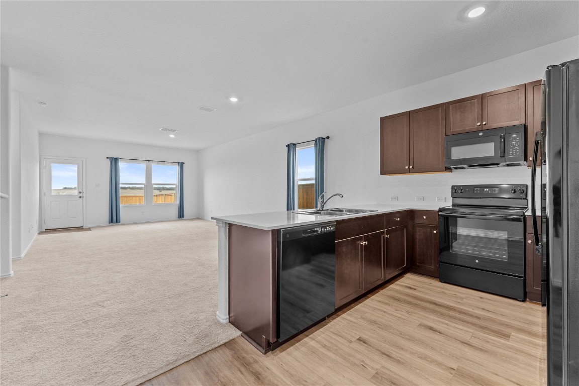 600 The Ugly Way Jarrell, TX 76537 - Photo 33 of 33 a large kitchen with cabinets and stainless steel appliances
