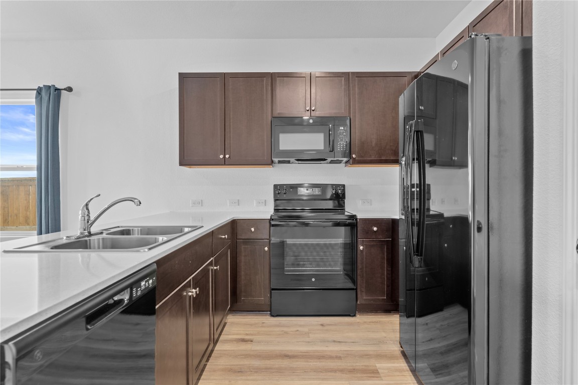 600 The Ugly Way Jarrell, TX 76537 - Photo 18 of 33 a kitchen with a refrigerator and a sink