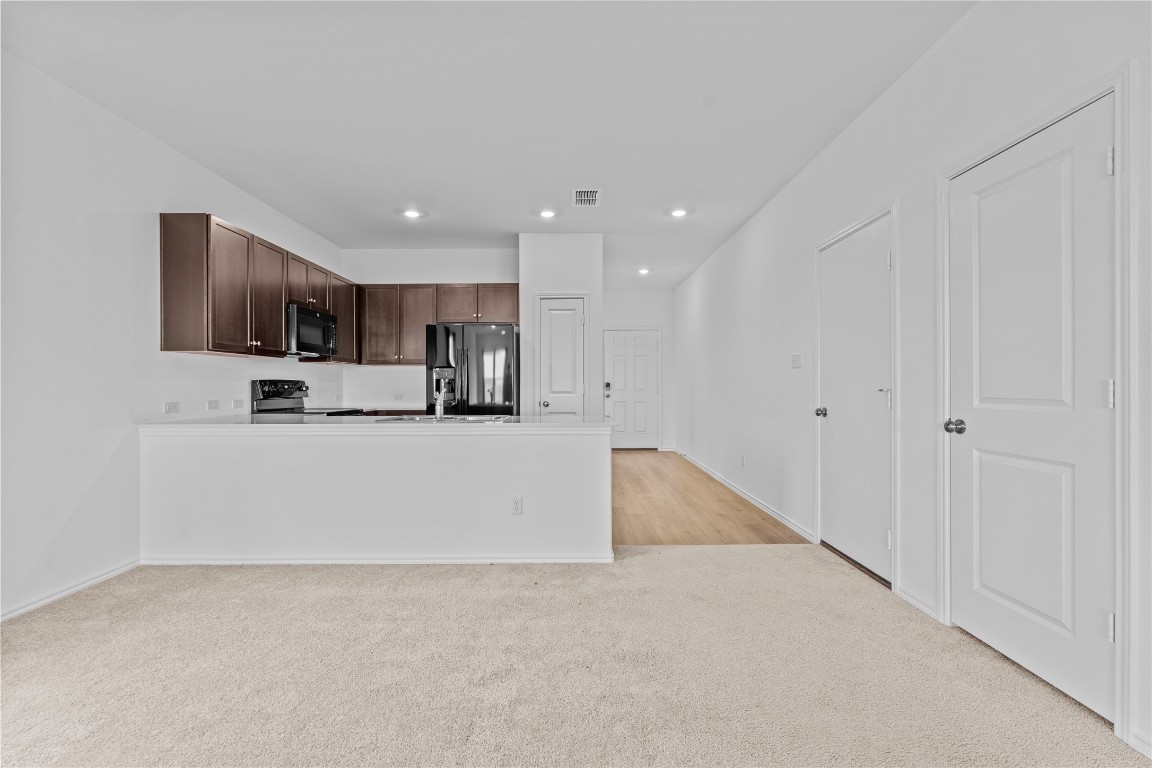 600 The Ugly Way Jarrell, TX 76537 - Photo 19 of 33 a view of kitchen with granite countertop cabinets and refrigerator