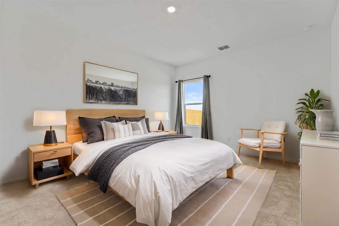 600 The Ugly Way Jarrell, TX 76537 - Photo 24 of 33 a bedroom with a bed and a potted plant