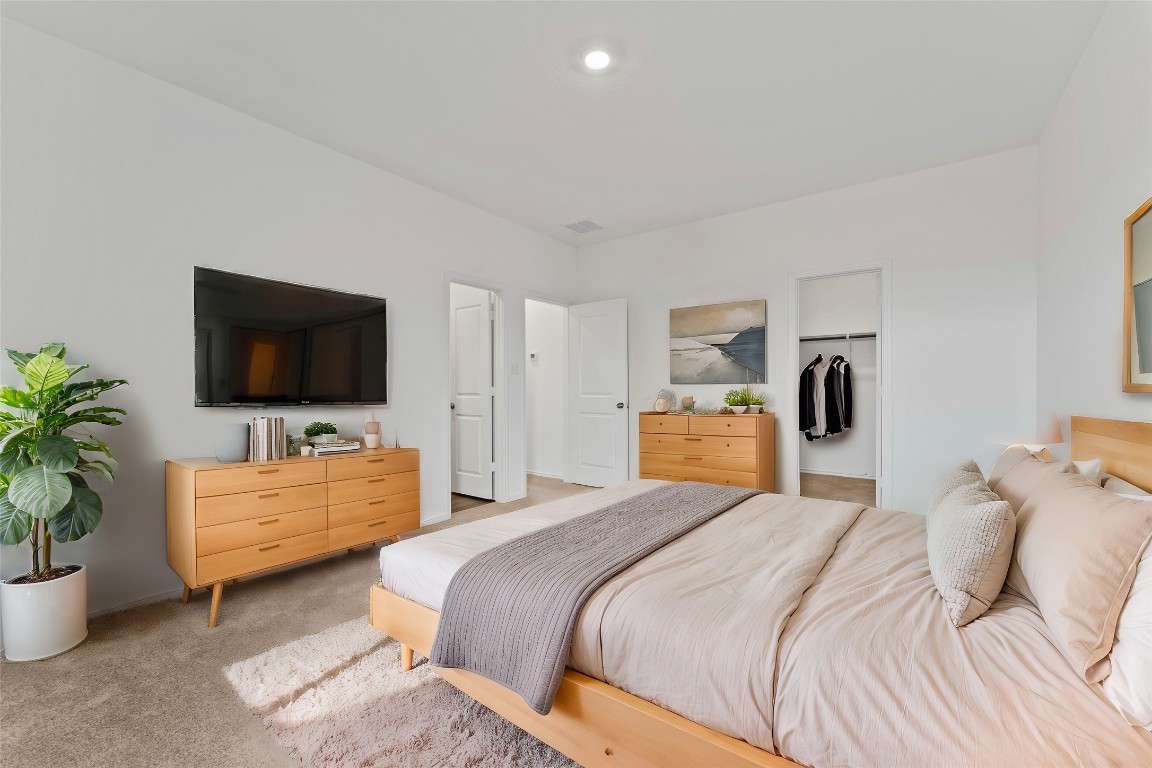 600 The Ugly Way Jarrell, TX 76537 - Photo 26 of 33 a bedroom with a bed and a flat screen tv