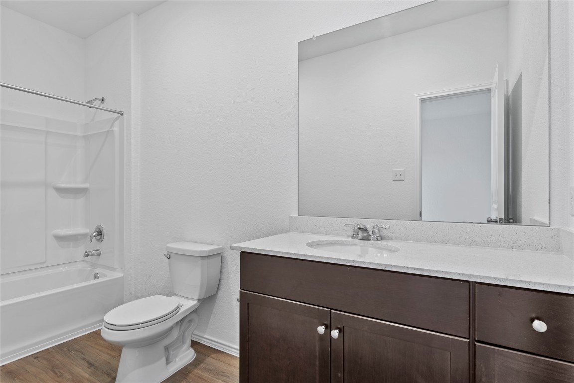 600 The Ugly Way Jarrell, TX 76537 - Photo 28 of 33 a bathroom with a sink toilet vanity and shower