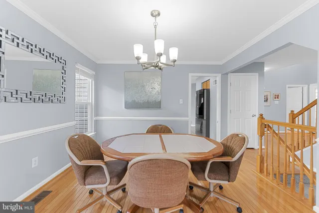 a view of a dining room with furniture and chandelier