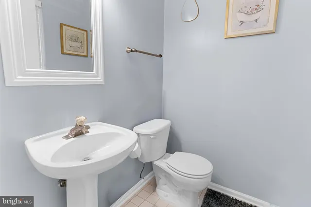a white toilet sitting next to a white sink
