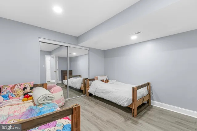 a bedroom with furniture and a book shelf