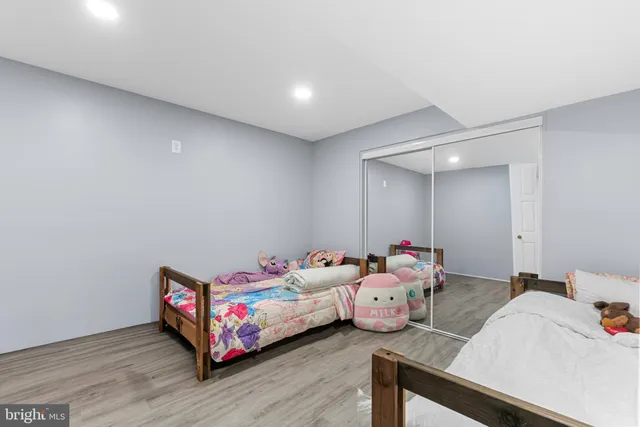 a bedroom with furniture and wooden floor