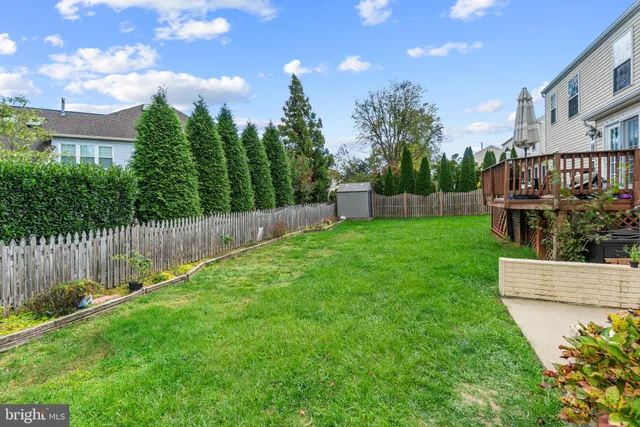 a view of a backyard with a garden and deck