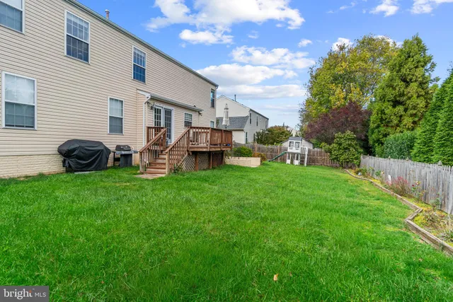a view of a house with a backyard and a patio