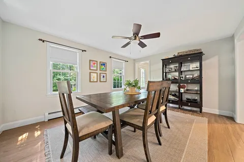 a view of a dining room with furniture and a window