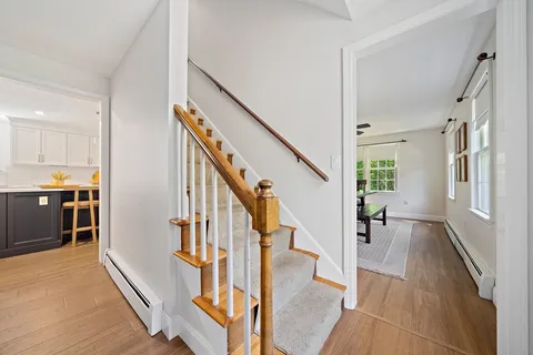 a view of an entryway with wooden floor and windows