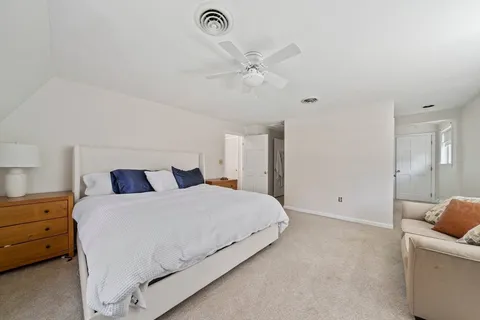 a bedroom with a bed and a couch