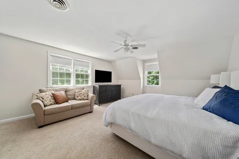 a bedroom with a bed and a couch