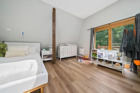 a bedroom with furniture and a large window