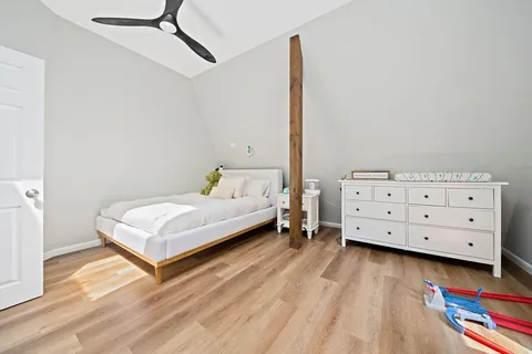 a bedroom with a bed and a dresser