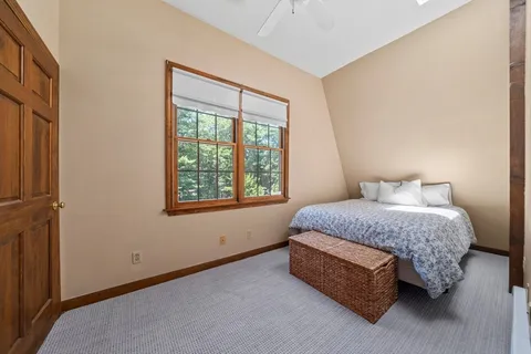 a bedroom with a bed lamp and window