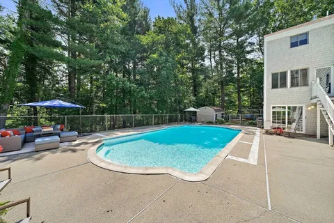 an outdoor space with swimming pool and barbeque oven