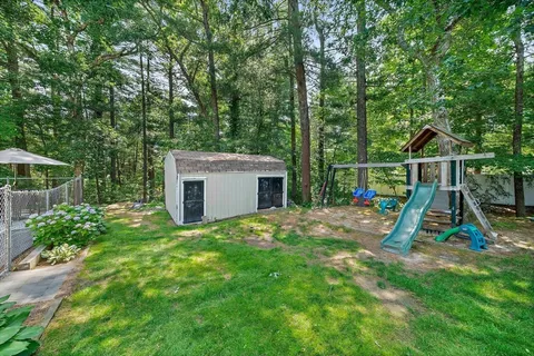 a view of a house with backyard and slide