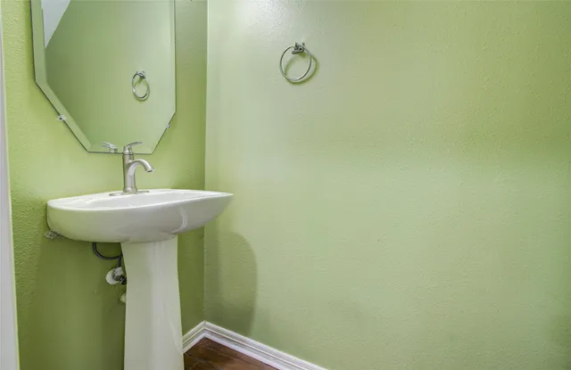 a bathroom with a sink a mirror and shower