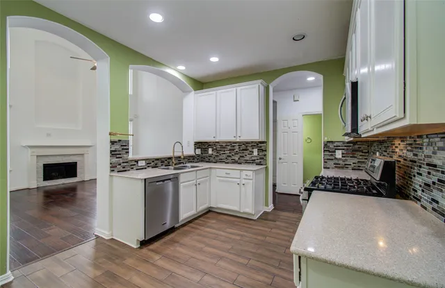 a kitchen with sink refrigerator and cabinets