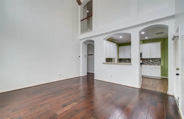 a view of a kitchen with wooden floor and a sink