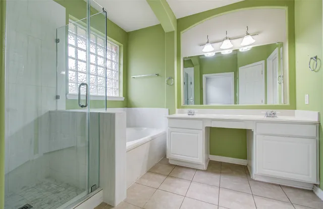 a bathroom with a bathtub a sink and a mirror