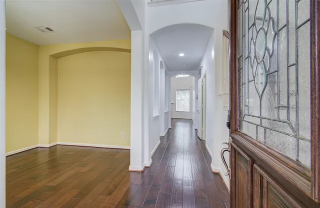 a view of a hallway with wooden floor